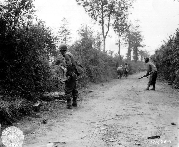 u_s_army_in_world_war_ii_photograph_of_gis_moving_cautiously_between_hedgerows_in_normandy